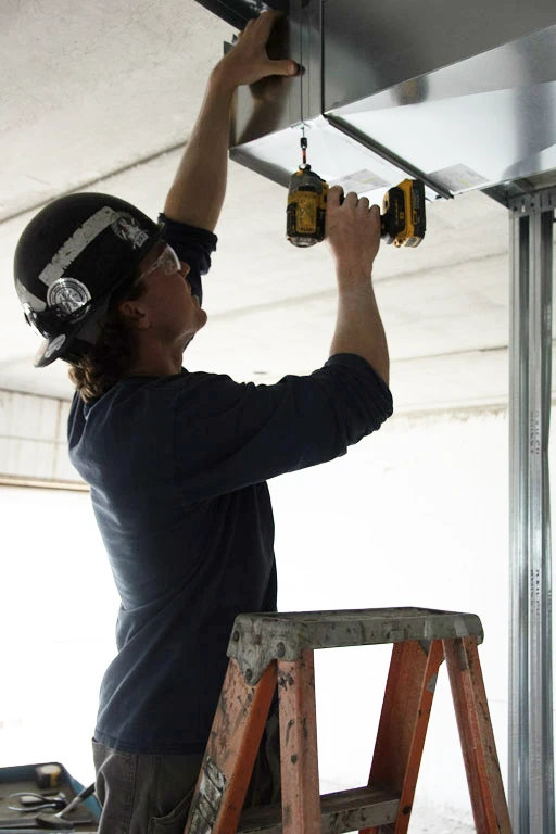 Worker securing HVAC system